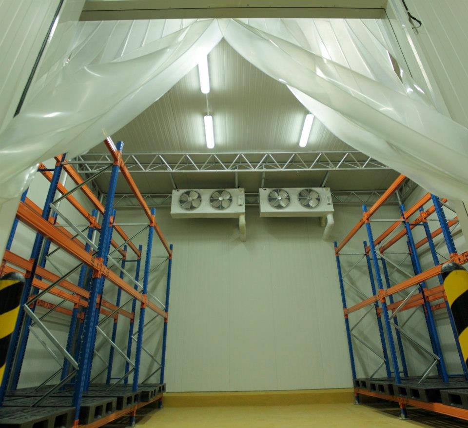 An empty cold room with pallet racking and ceiling evaporators