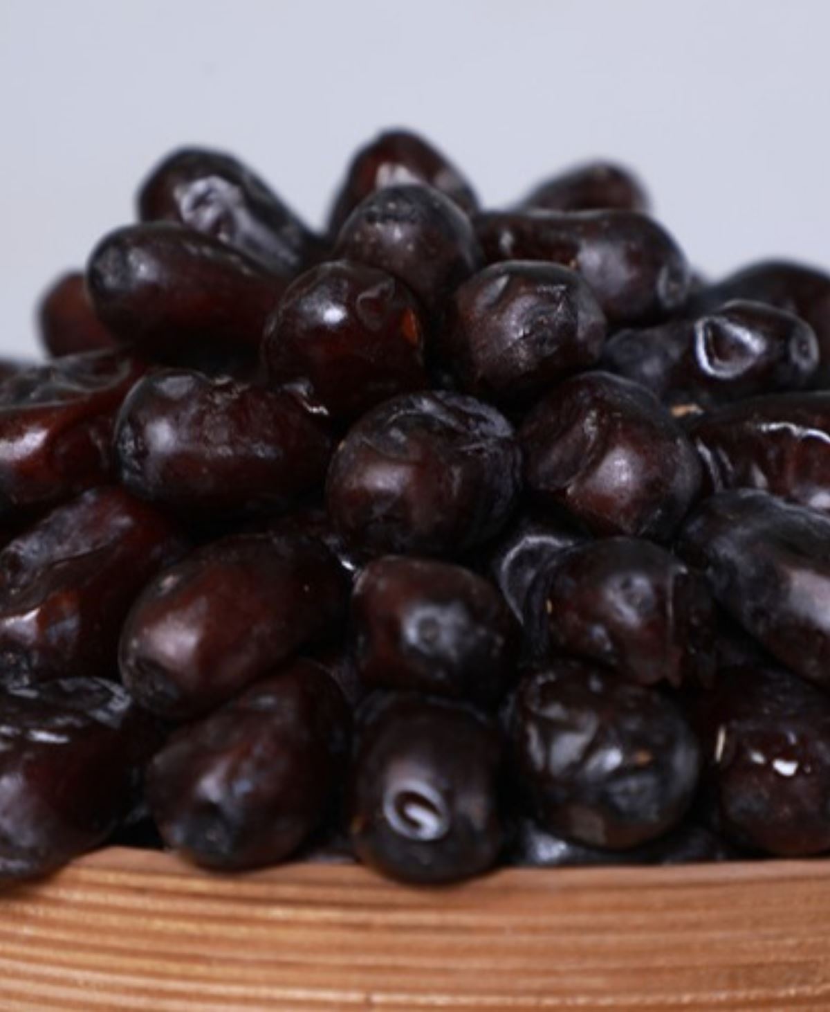 Mazafati dates heaped high in a wooden bowl