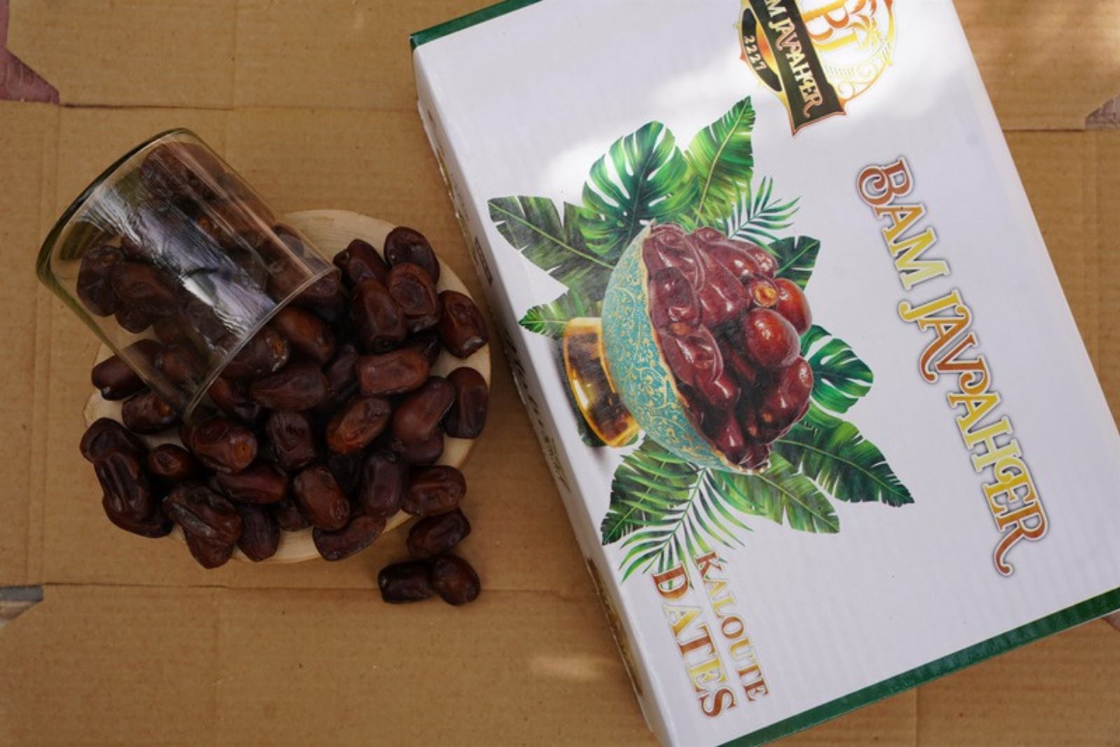 Existing BAM JAVAHER retail box next to a glass of dates